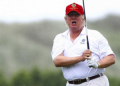Trump playing golf.